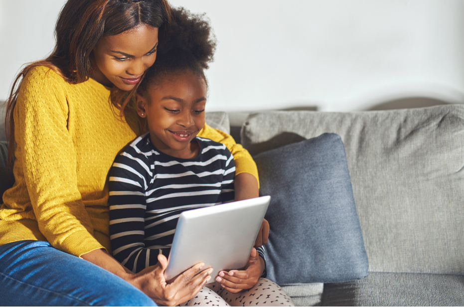 Mother and child reading together on the couch